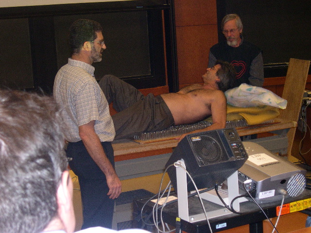 Joe Rudnick setting up on bed of nails.JPG